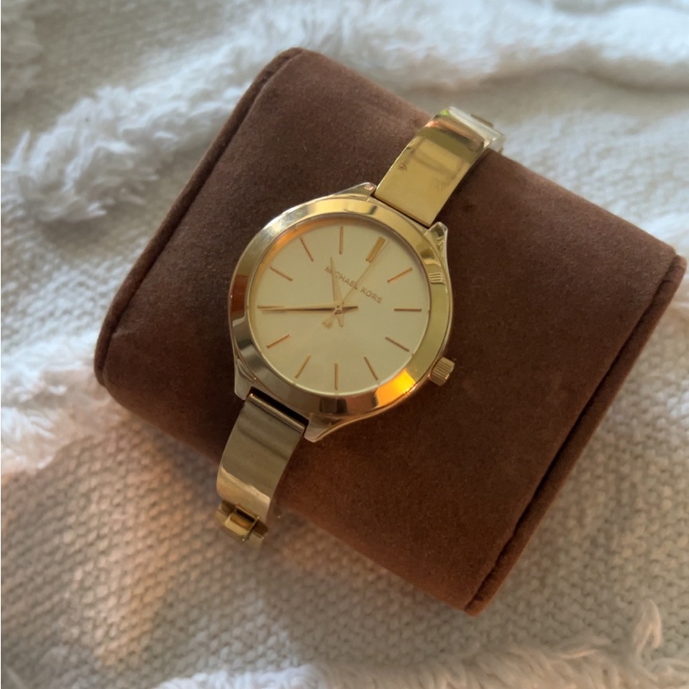 Woman’s Michael Kors gold watch